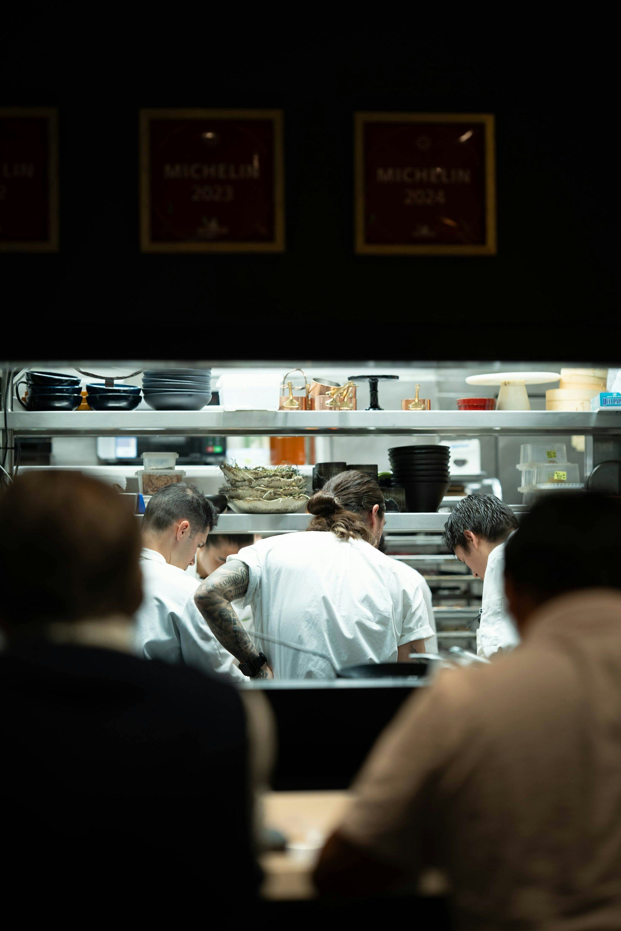 Team of chefs working together during service in a busy restaurant kitchen