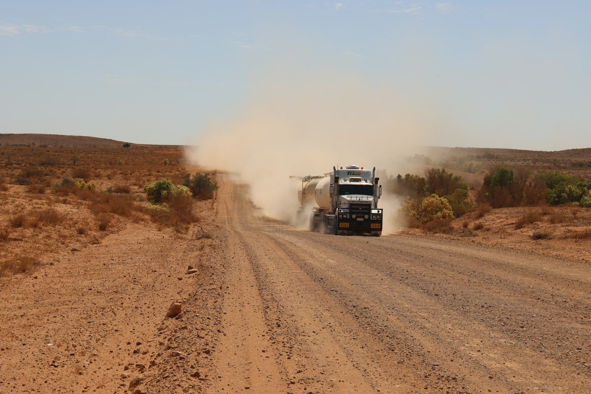 Truck travelling along the Strzelecki Track dirt road through arid outback South Australia